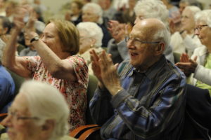 Seniors enjoying the Musical Meet & Greet at The Redwoods Retirement Community Auditorium